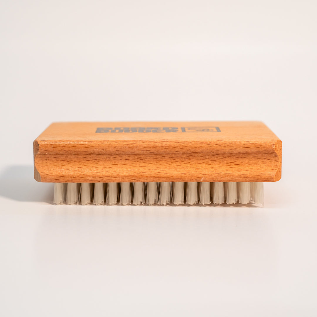 Budder Brush with nylon bristles face down, ideal for waxing skis and snowboards.