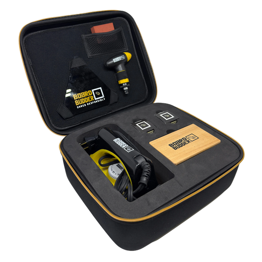 Black carrying case with ski tuning tools and equipment, featuring board budder glide wax